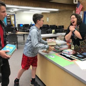 Student checking out library book